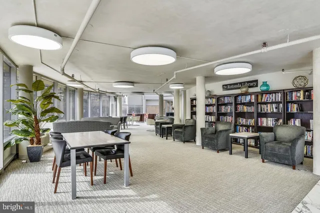 a view of a patio with a table and chairs and potted plants