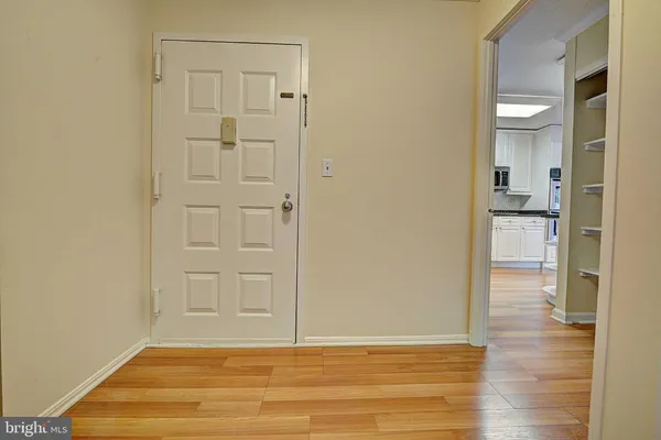 a view of empty room with wooden floor