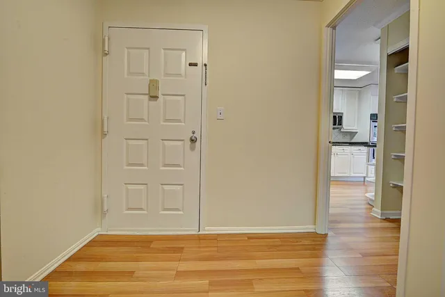 a view of empty room with wooden floor