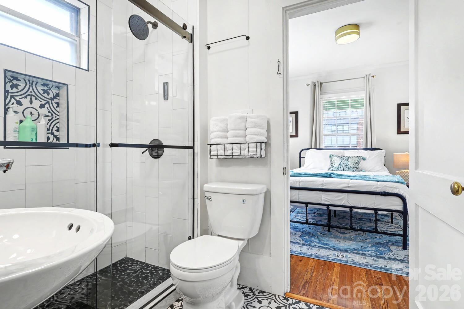 335 South Torrence Street Charlotte, NC 28204 - Photo 11 of 21 a bathroom with a sink toilet and shower