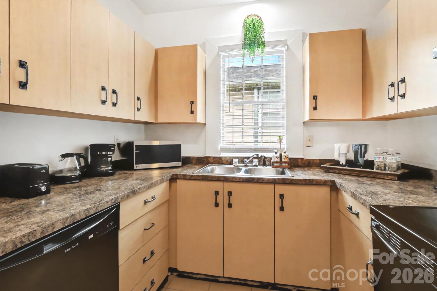 335 South Torrence Street Charlotte, NC 28204 - Photo 18 of 21 a kitchen with granite countertop white cabinets and a sink