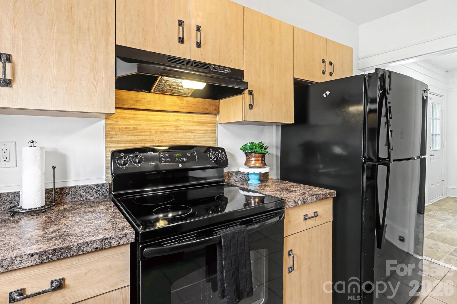 335 South Torrence Street Charlotte, NC 28204 - Photo 19 of 21 a kitchen with granite countertop a stove and a refrigerator