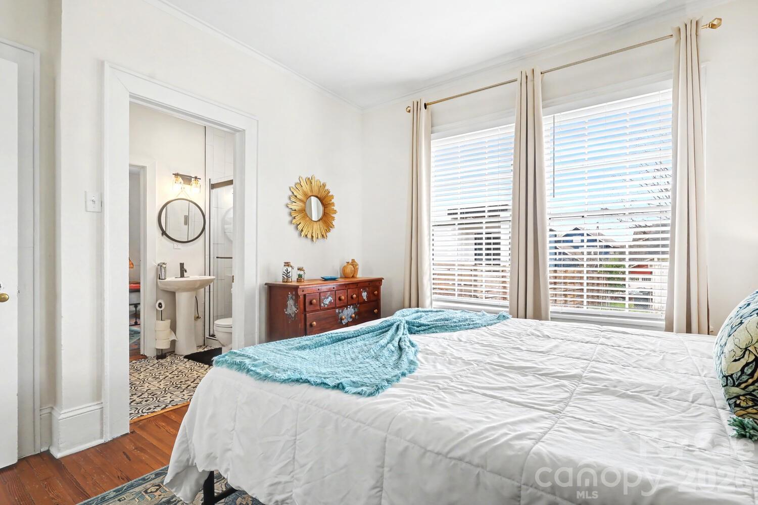 335 South Torrence Street Charlotte, NC 28204 - Photo 10 of 21 a bedroom with a bed and a chandelier