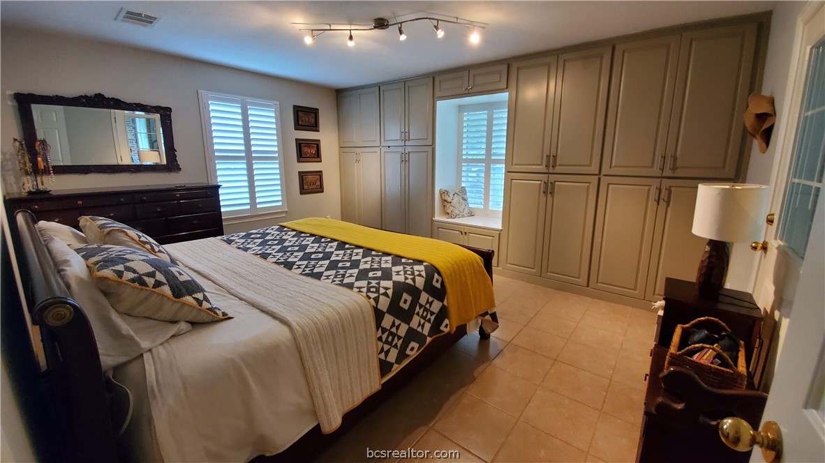 5660 Falling Water Bryan, TX 77808 - Photo 8 of 27 Tiled bedroom with a closet