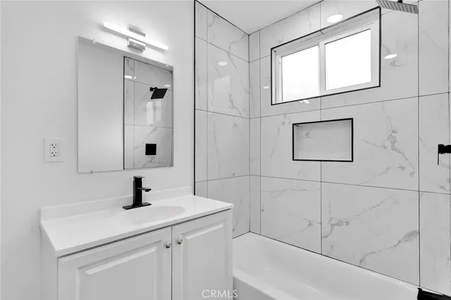 a bathroom with a sink and mirror with window