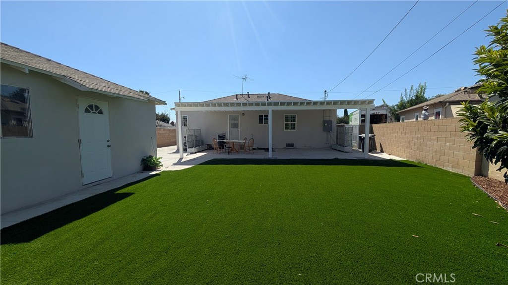 4432 Ranger Avenue El Monte, CA 91731 - Photo 20 of 24 Rear yard with artificial turf. View of back of the house and side of garage.