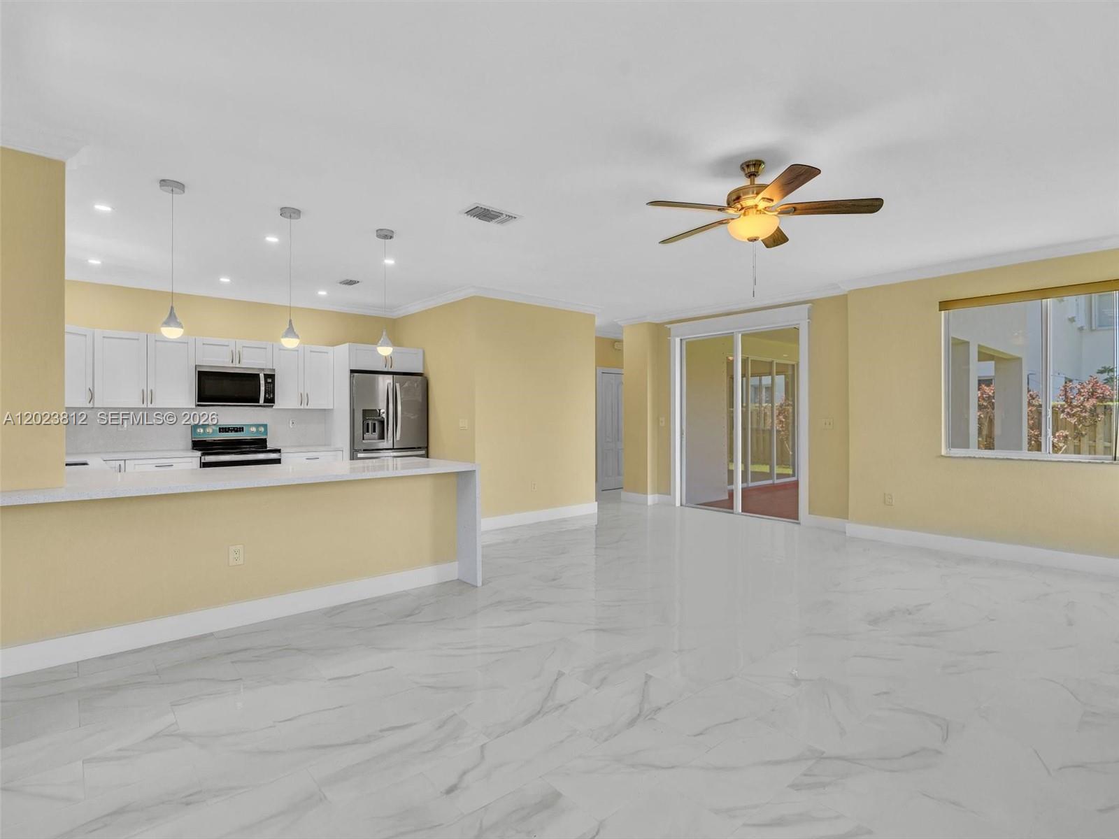 2864 Southwest 138th Path Miami, FL 33175 - Photo 17 of 40 a view of an empty room with a window and a kitchen