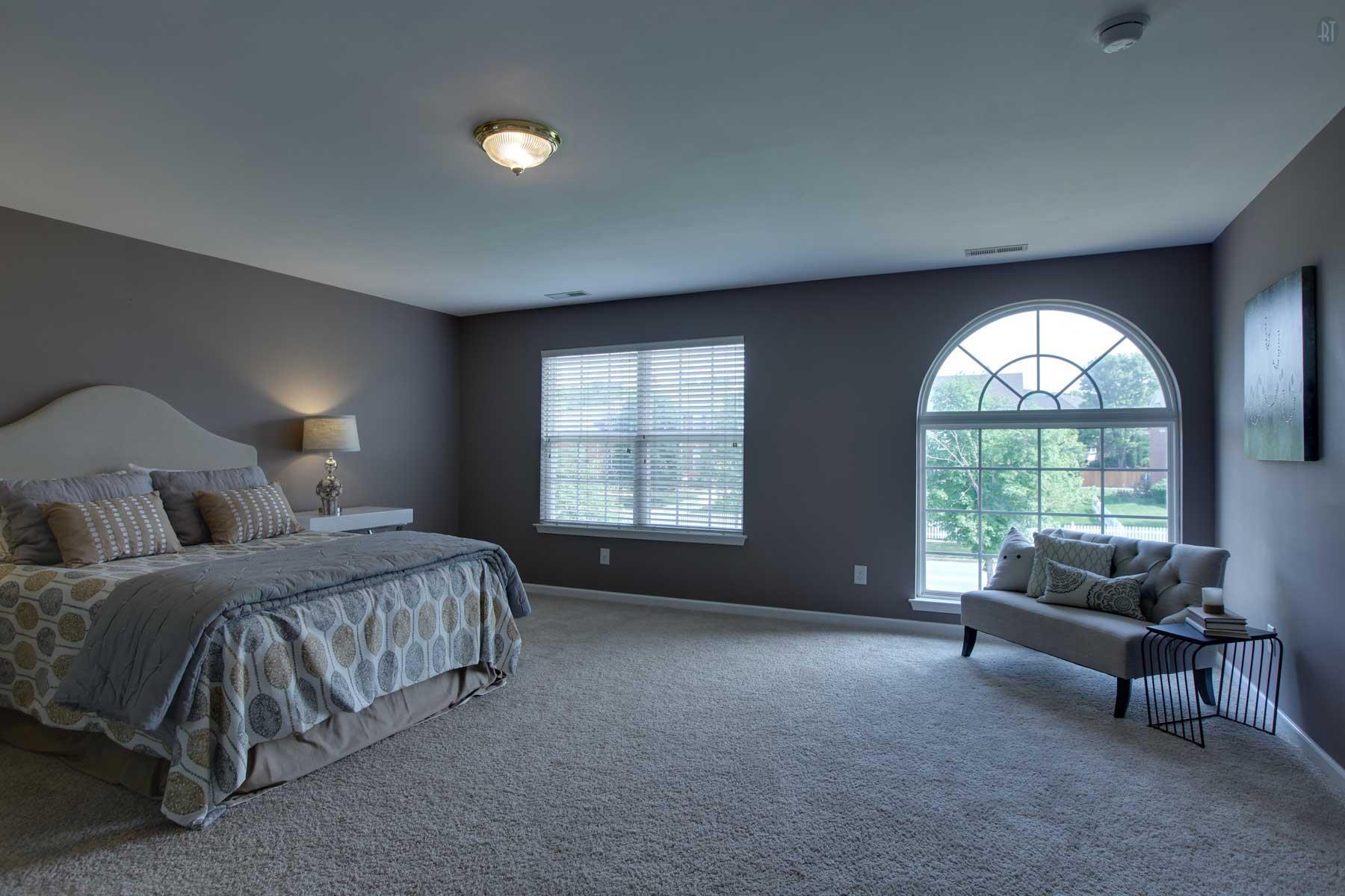 1735 Liberty Pike Franklin, TN 37067 - Photo 21 of 30 a spacious bedroom with a bed and a couch