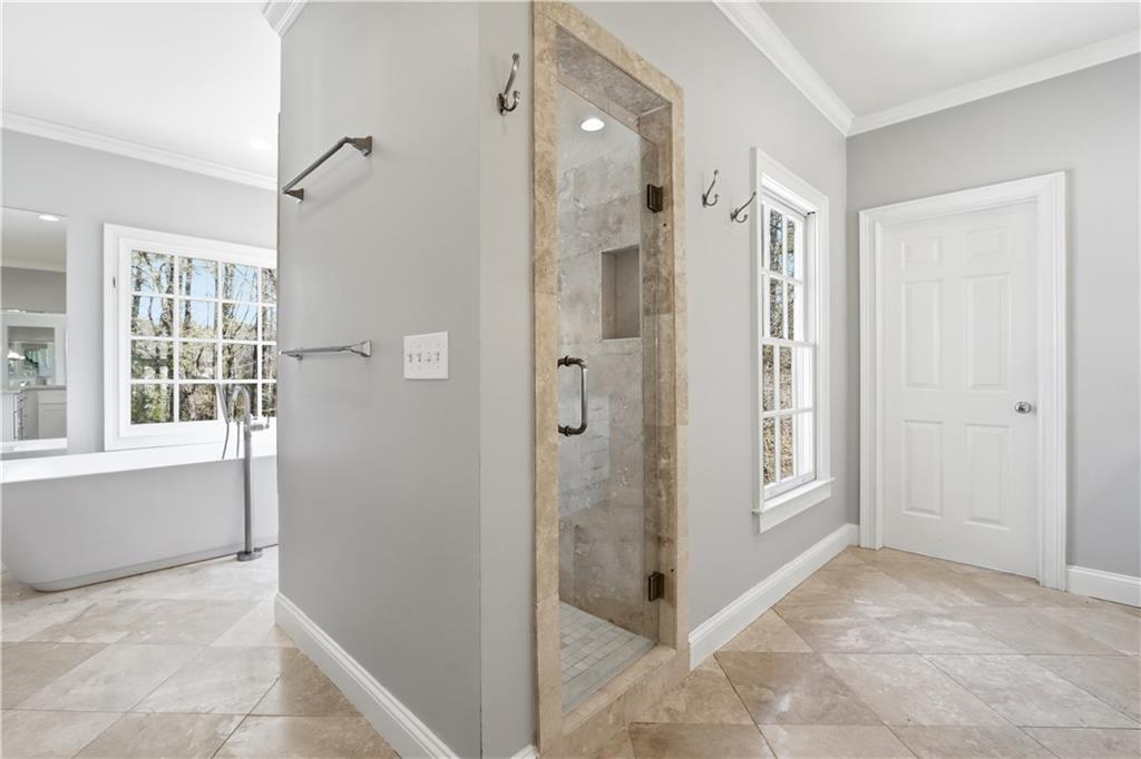 1124 Moores Mill Road Northwest Atlanta, GA 30327 - Photo 24 of 45 a bathroom with a shower and a glass door