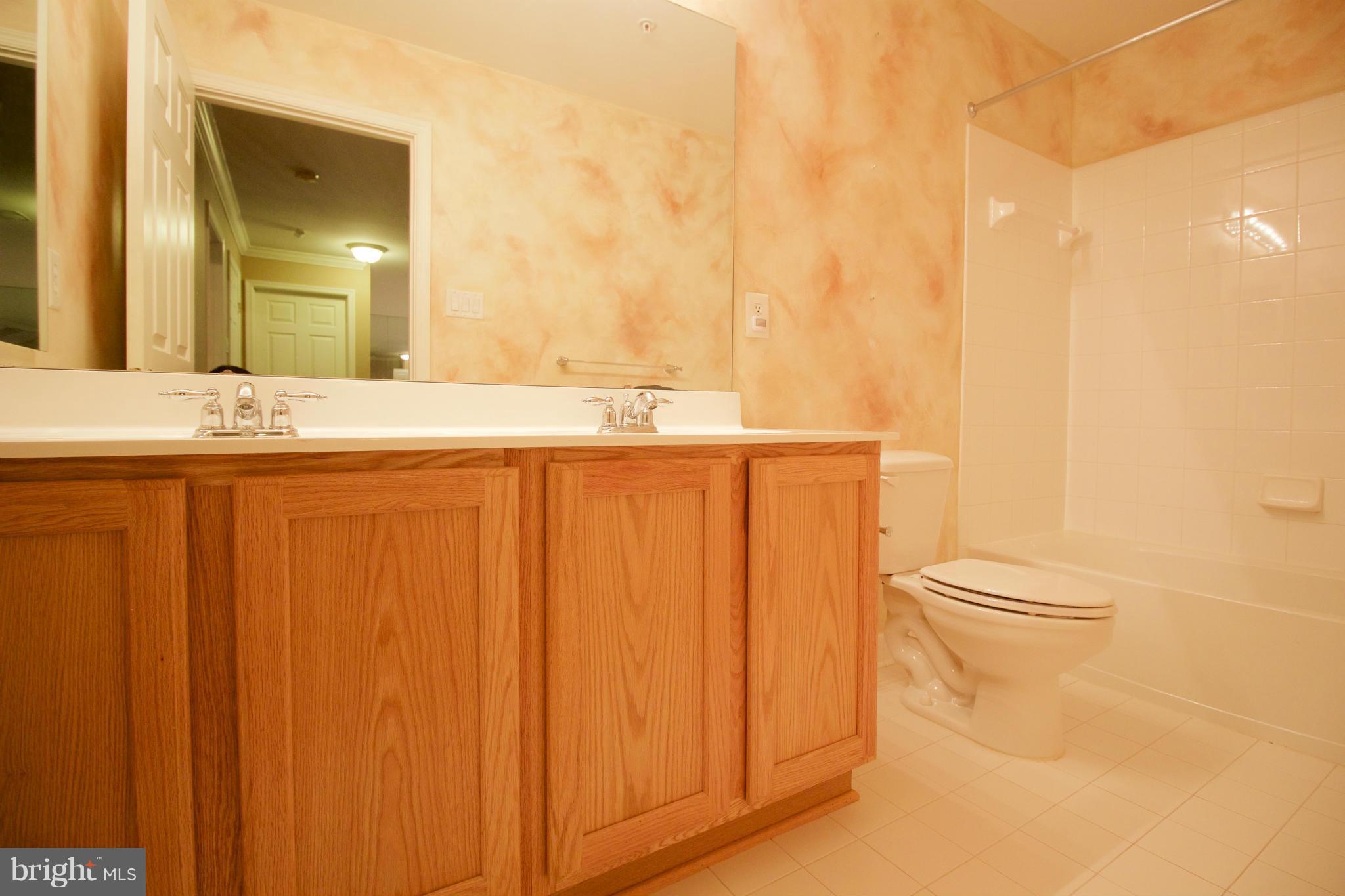8411 Meadowsweet Road Pikesville, MD 21208 - Photo 21 of 30 a bathroom with a granite countertop sink and a mirror