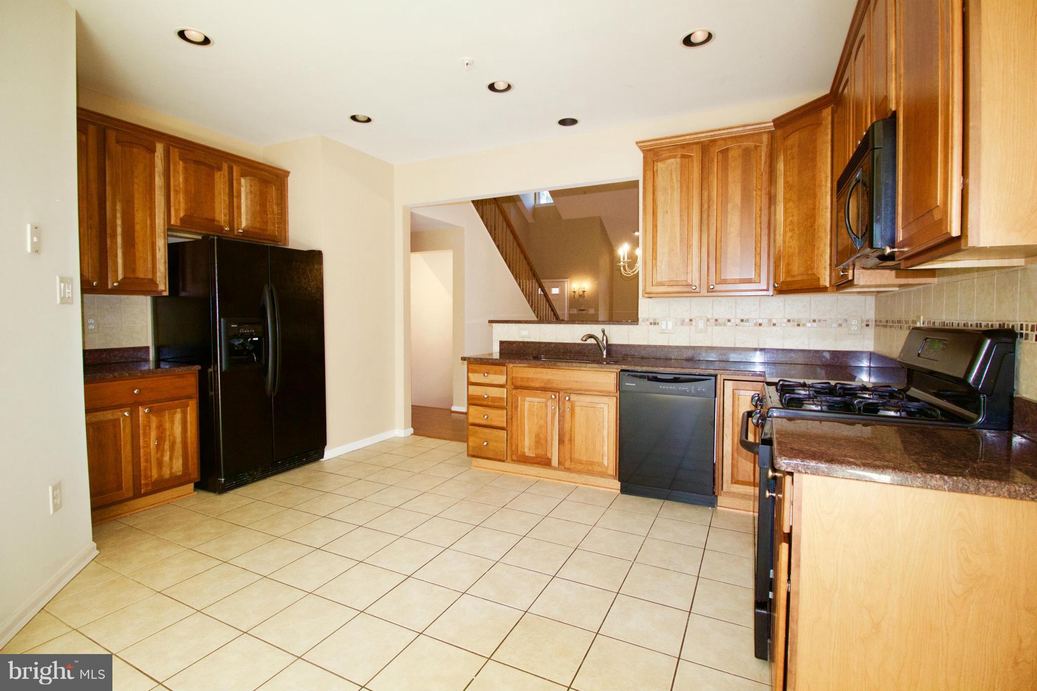 8411 Meadowsweet Road Pikesville, MD 21208 - Photo 8 of 30 a kitchen with a stove a refrigerator and a sink