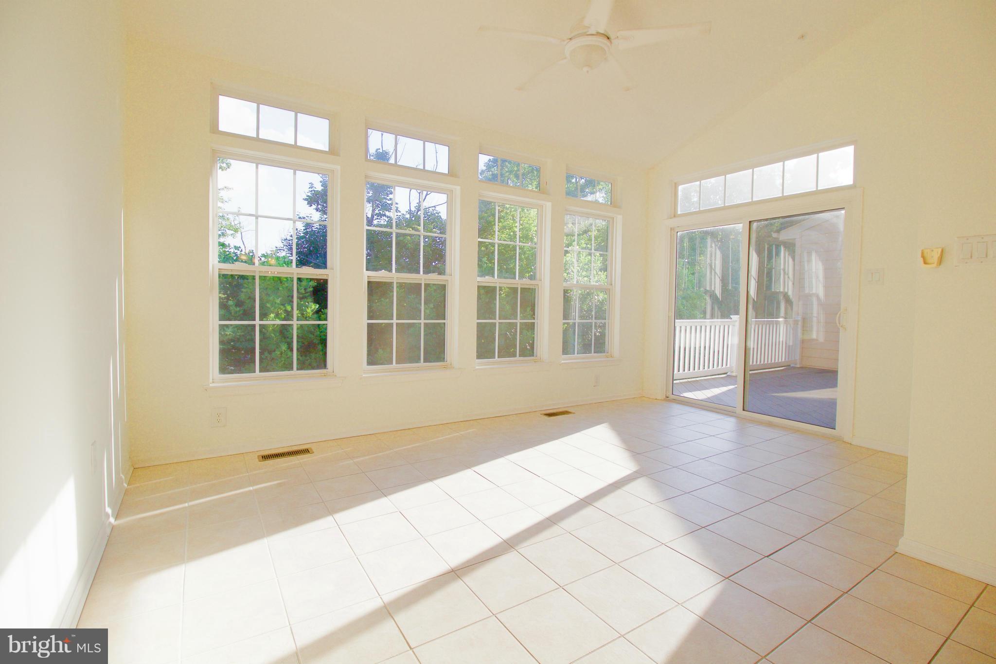 8411 Meadowsweet Road Pikesville, MD 21208 - Photo 10 of 30 a view of an empty room with wooden floor and a window