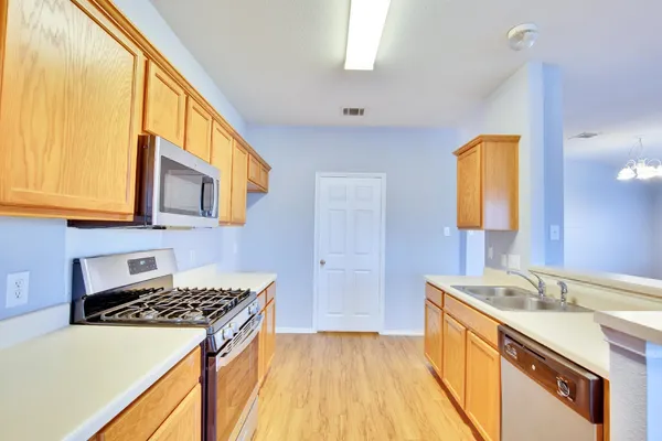 a kitchen that has a sink and a stove
