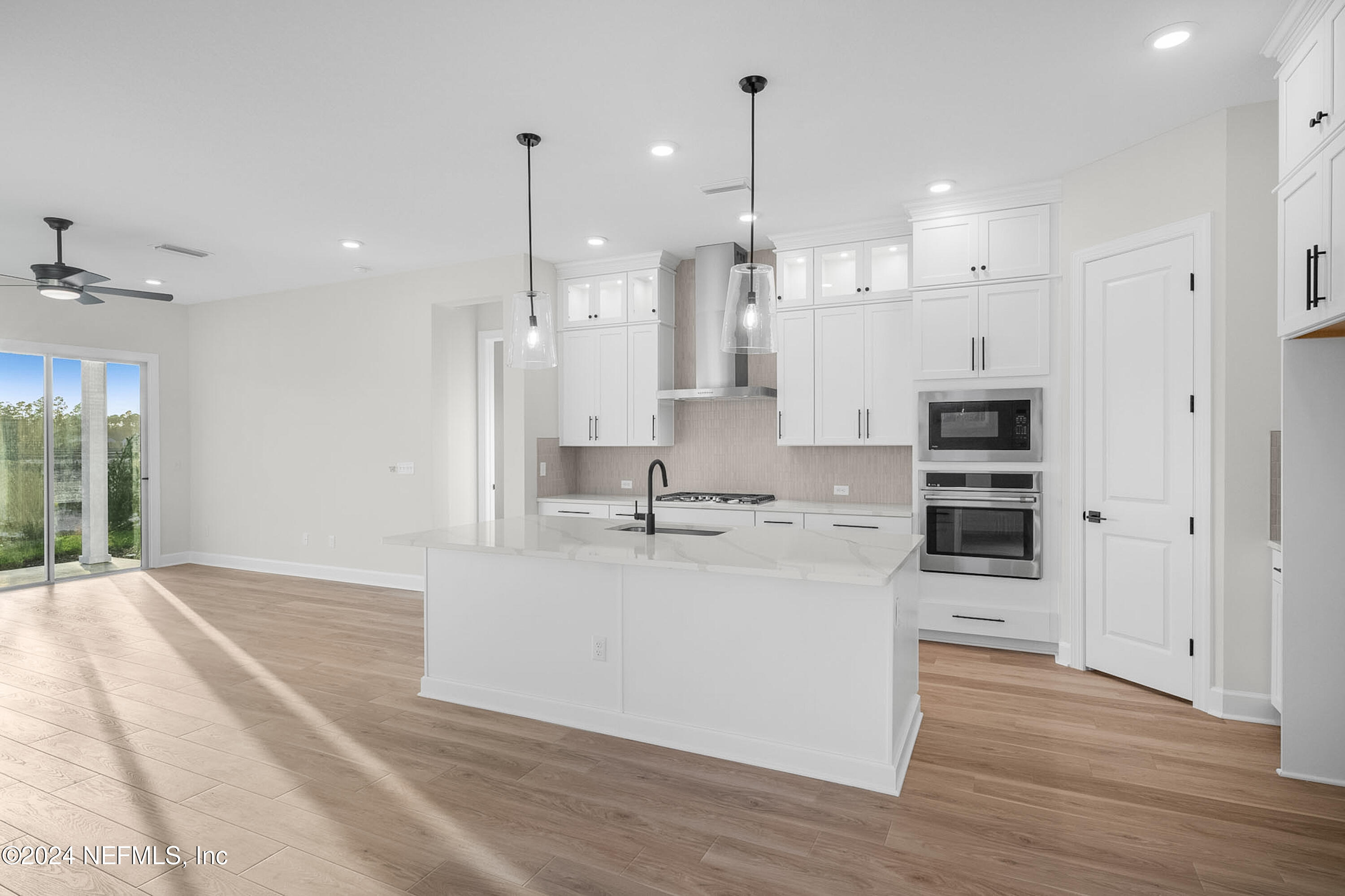 5620 Pathfinder Road Jacksonville, FL 32224 - Photo 9 of 19 a large room with kitchen island a sink stainless steel appliances and cabinets