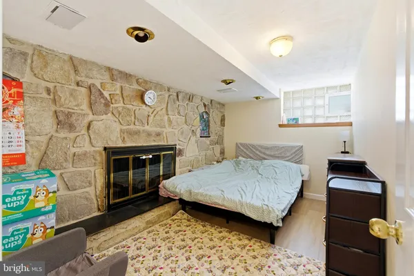 a bedroom with a bed and a fireplace