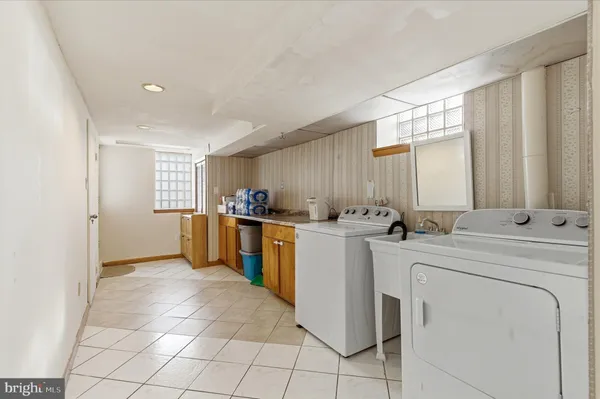 a view of kitchen with refrigerator and window