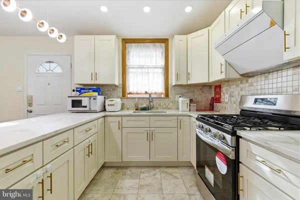 a kitchen with appliances cabinets and a sink