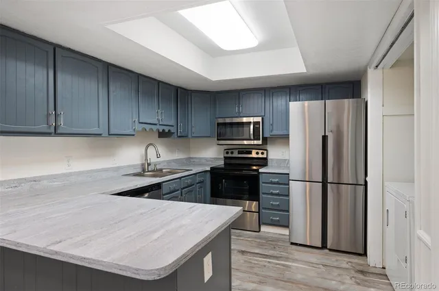 a kitchen with wooden cabinets and stainless steel appliances