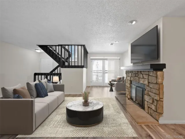 a living room with fireplace furniture and a flat screen tv