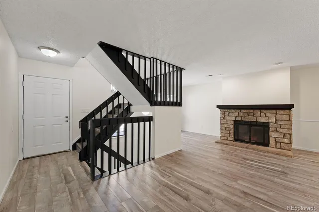 a view of a livingroom with wooden floor and staircase