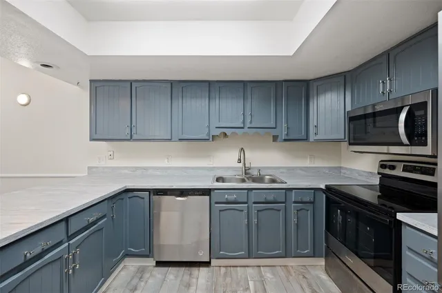 a kitchen with stainless steel appliances granite countertop a sink stove and microwave
