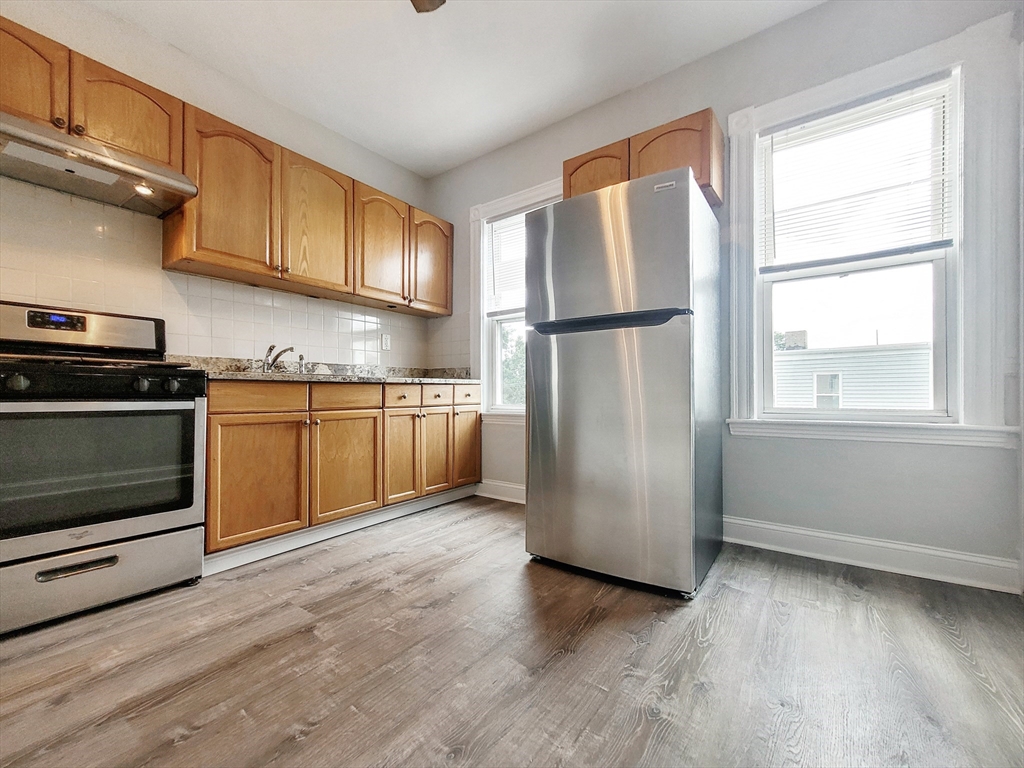 35 Dunlap Street, Unit 3 Boston, MA 02124 - Photo 1 of 9 a kitchen with stainless steel appliances granite countertop a refrigerator a sink a stove and cabinets