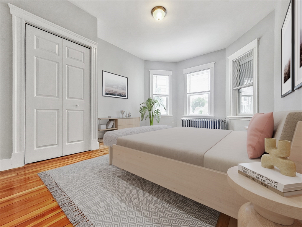35 Dunlap Street, Unit 3 Boston, MA 02124 - Photo 4 of 9 a bedroom with a bed and wooden floor