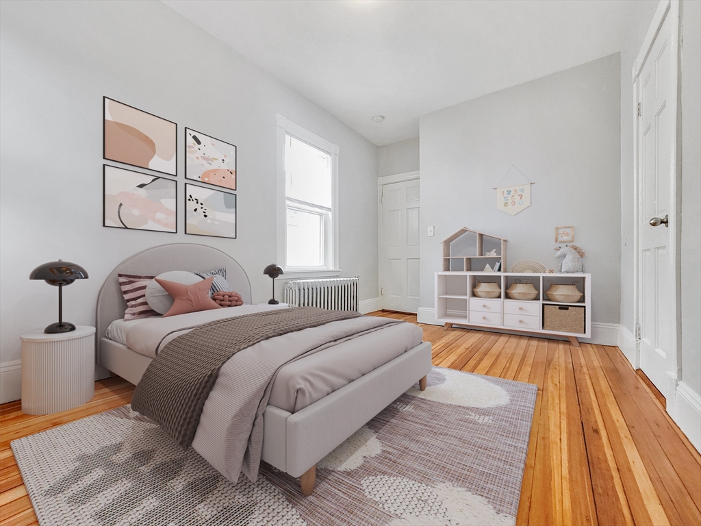 35 Dunlap Street, Unit 3 Boston, MA 02124 - Photo 6 of 9 a spacious bedroom with a bed and a couch