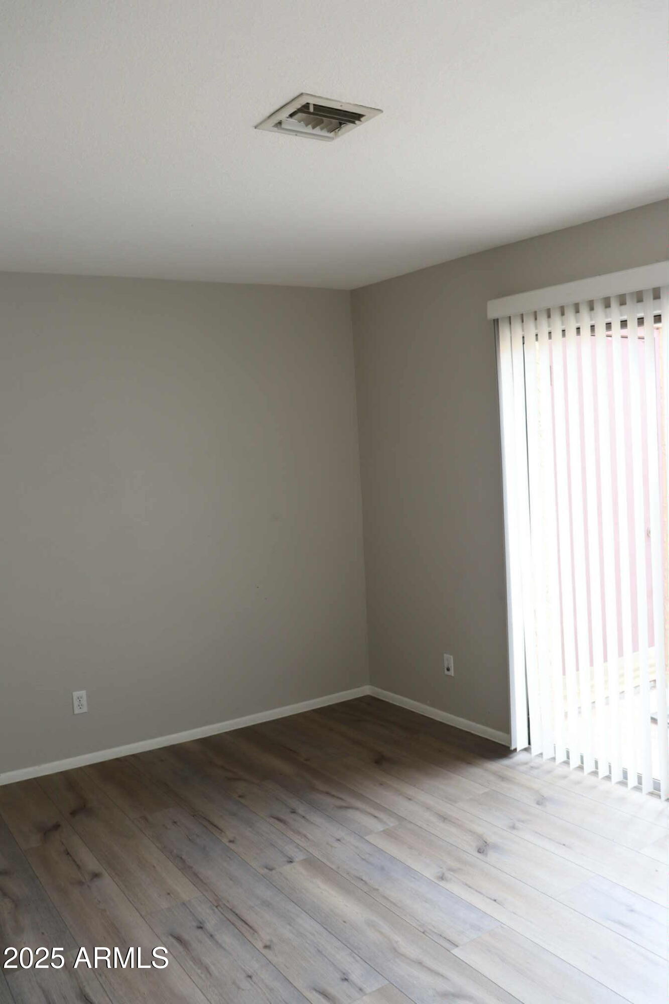 653 West Guadalupe Road, Unit 2005 Mesa, AZ 85210 - Photo 13 of 27 an empty room with wooden floor and windows