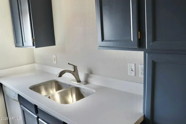a kitchen with a sink and cabinets