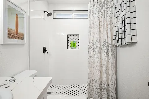a bathroom with a bathtub and shower