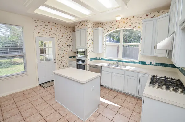 a kitchen with a stove a sink and a refrigerator