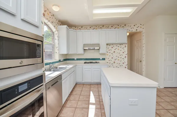 a kitchen with a sink stove and microwave