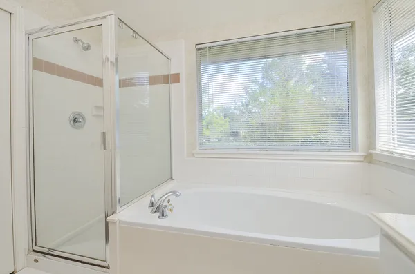 a bath tub sitting next to a window