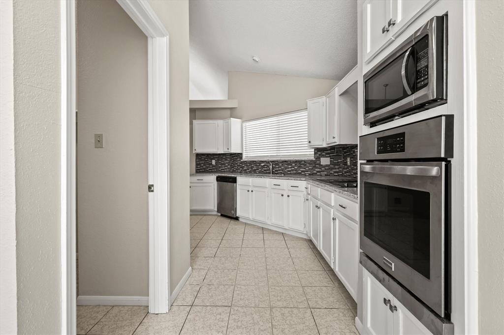 1113 Kit Lane Plano, TX 75023 - Photo 12 of 31 a kitchen with stainless steel appliances granite countertop a refrigerator and a stove top oven