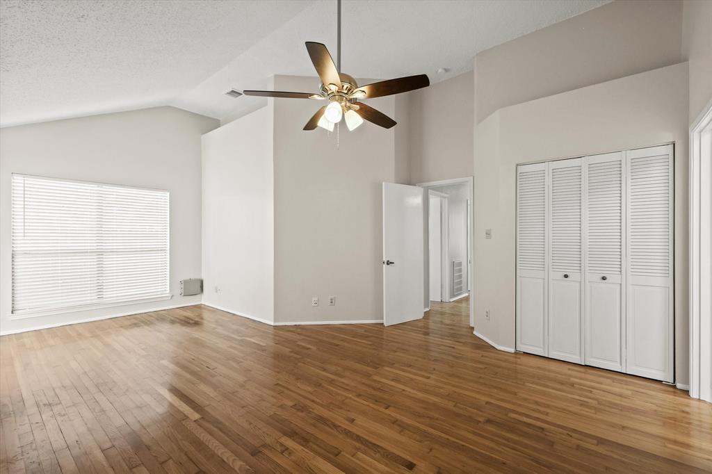 1113 Kit Lane Plano, TX 75023 - Photo 18 of 31 an empty room with wooden floor closet and windows