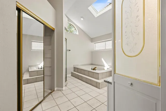 a room with table mirror and a painting on the wall