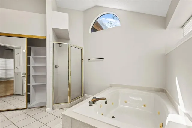 a bathroom with a tub and shower