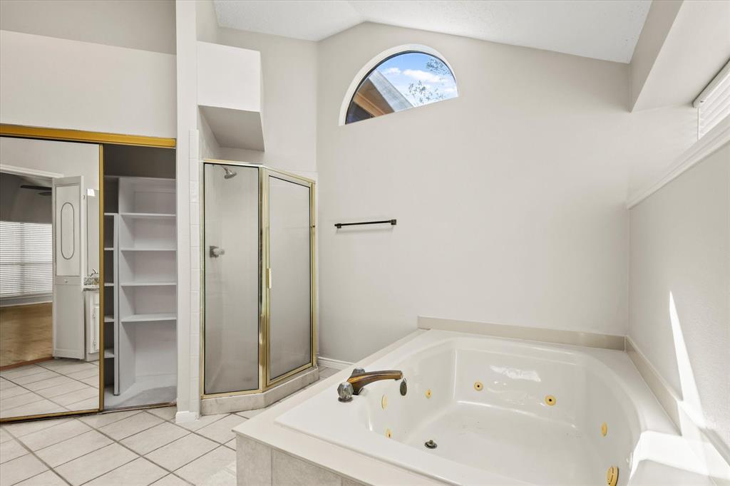 1113 Kit Lane Plano, TX 75023 - Photo 20 of 31 a bathroom with a tub and shower
