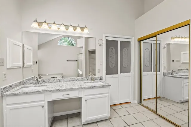 a bathroom with a sink vanity and a mirror
