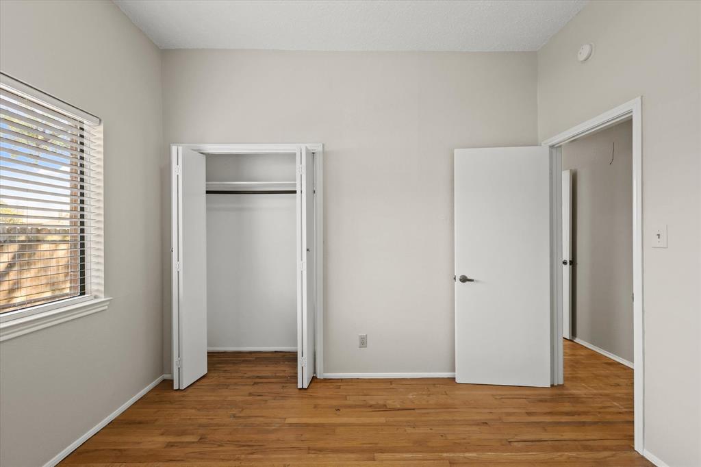 1113 Kit Lane Plano, TX 75023 - Photo 23 of 31 a view of an empty room with wooden floor and a window