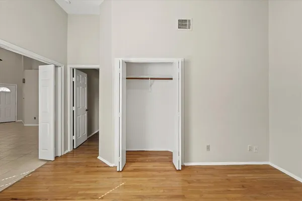a view of an empty room with wooden floor