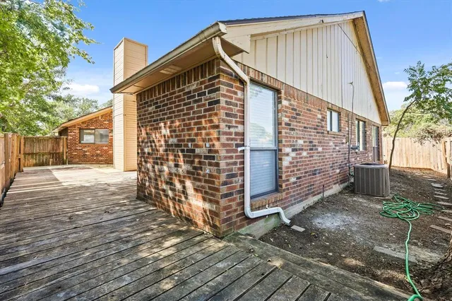 a view of a house with wooden fence