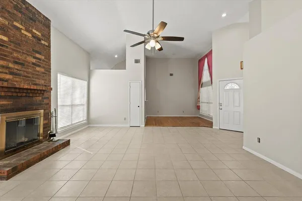 a view of an empty room with a fireplace