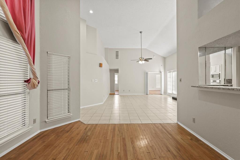 1113 Kit Lane Plano, TX 75023 - Photo 9 of 31 a view of a hallway with wooden floor and staircase