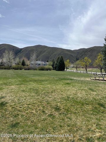 a view of grassy field with mountain