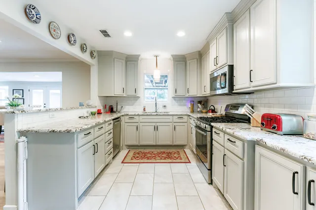 a stove top oven sitting inside of a kitchen