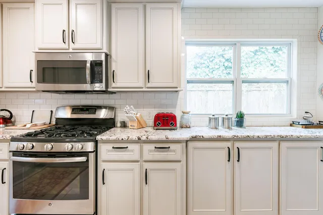 a kitchen with granite countertop a sink and a window