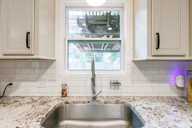 a kitchen with stainless steel appliances granite countertop a refrigerator and a sink