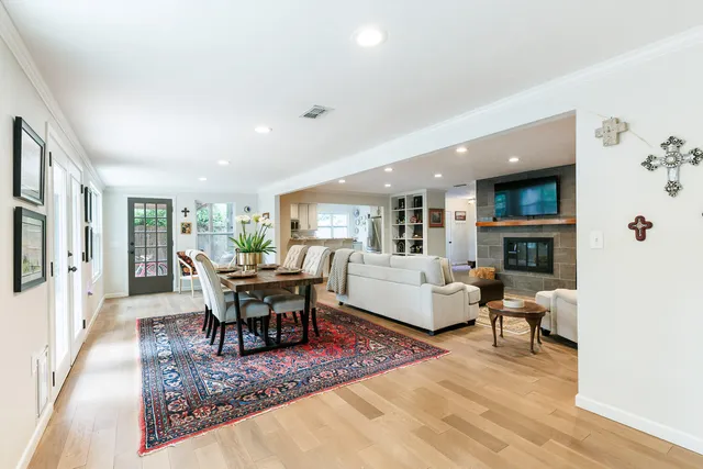 a living room with furniture and a book shelf